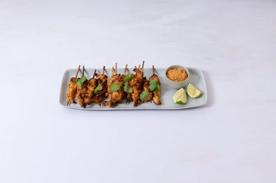 A platter of marinated and BBQ chicken thighs served with house peanut sauce, fresh lime and coriander. Perfect for a party! 10 skewers.