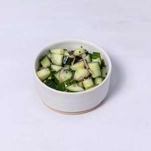 Salted and pickled cucumber with red onion, sesame and coriander. 1 serving.