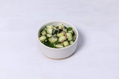 Salted and pickled cucumber with red onion, sesame and coriander. 1 serving.