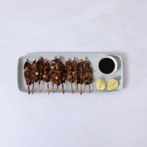 A platter of marinated teriyaki beef skewers served with unagi sauce, fresh lime and coriander. Perfect for a party! 10 skewers.